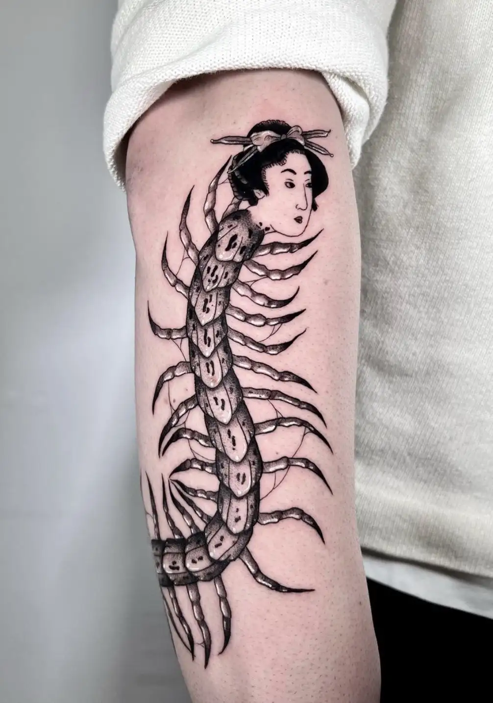 Japanese-inspired centipede tattoo with traditional character head by Ayah at Omnia Tattoo Melbourne